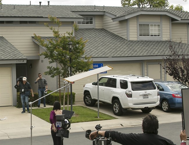 Members of the media stand outside the home of Syed Raheel Farook, the elder brother of San Bernardino gunman Syed Rizwan Farook, after the FBI served a warrant to the location, in Corona, Calif., Thursday, April 28, 2016. Syed Raheel Farook was arrested with two others Thursday in what prosecutors say was a marriage scheme to fraudulently allow one of them to remain in the United States.