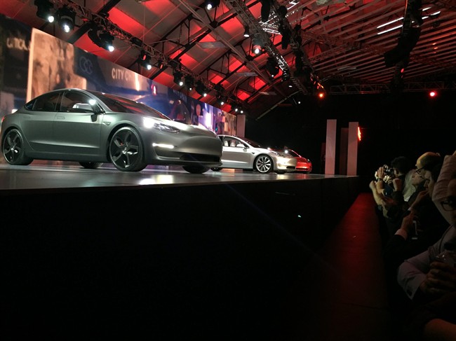 Tesla Motors unveils its Model 3 car at the Tesla Motors design studio Thursday, March 31, 2016, in Hawthorne, Calif. 