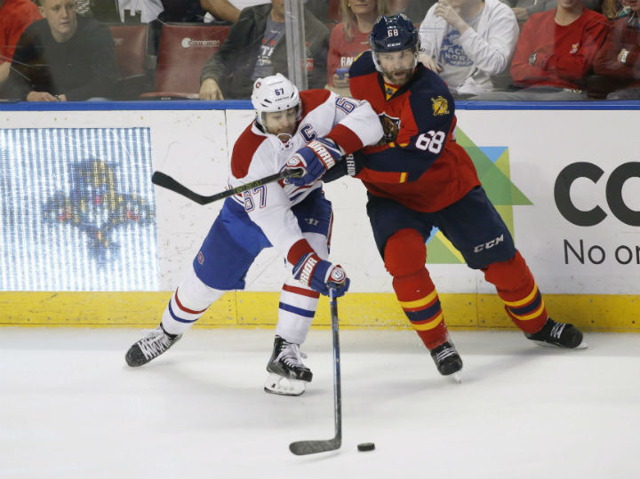 Montreal Canadiens left wing Max Pacioretty (67) and Florida Panthers right wing Jaromir Jagr (68) battle for the puck during the third period of an NHL hockey game, Saturday, April 2, 2016.