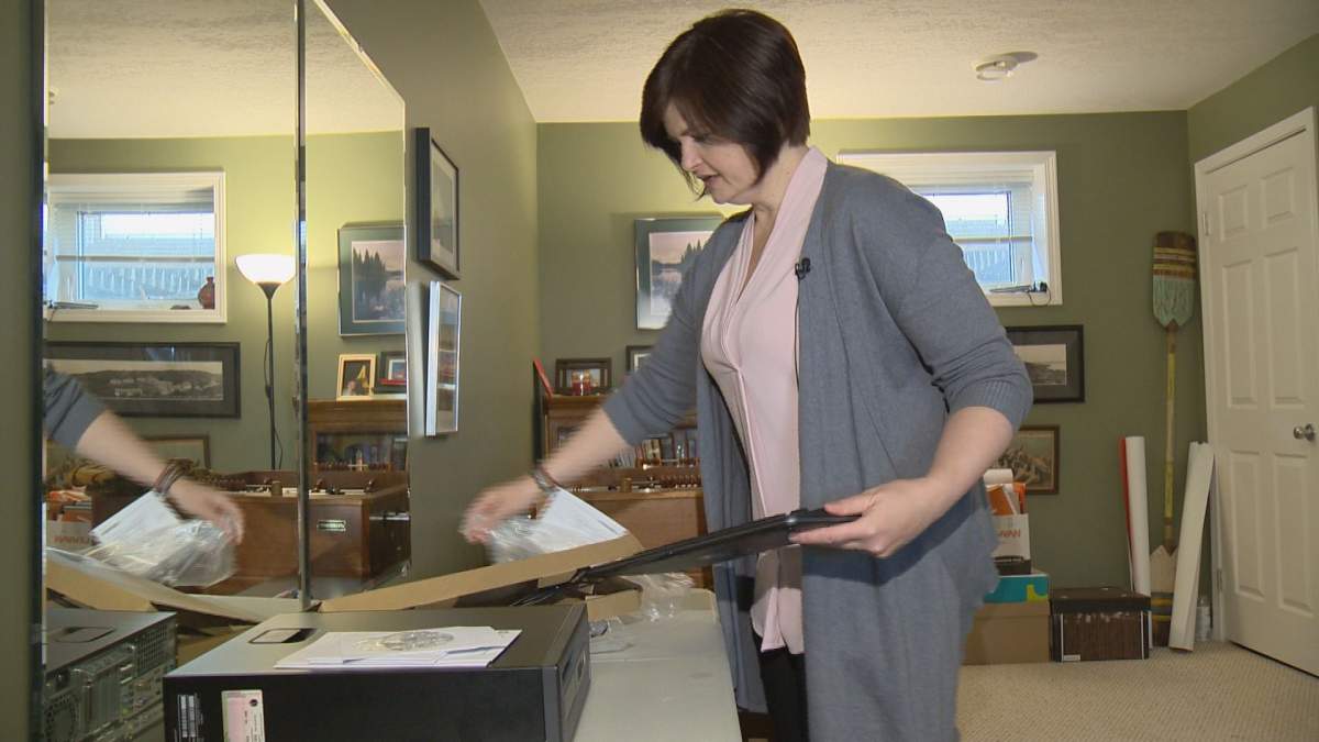 Carla Beck unpacks a computer at her temporary constituency office.