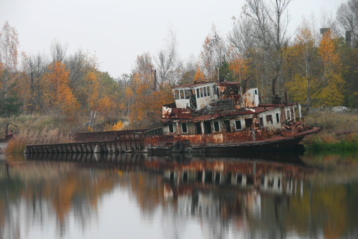 A rusted boat is abandoned, too contaminated with radiation to be salvaged.