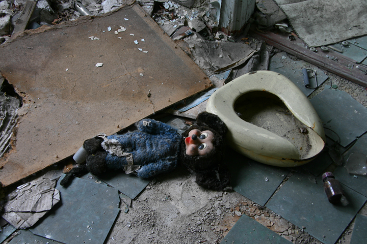 A doll lies beside a bed pan and a vial of medicine in a hospital in Pripyat, Ukraine.