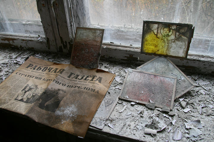 Old newspapers and crumbling paint in a building in Pripyat, Ukraine.
