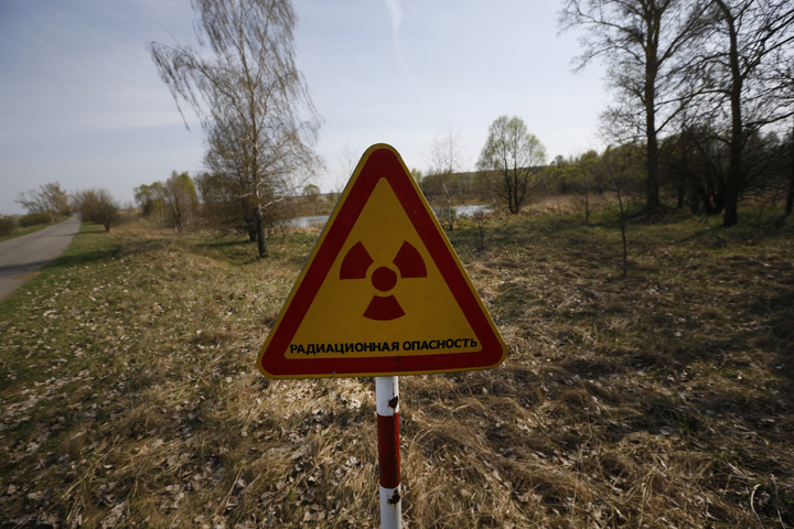 A radiation warning sign is placed near the checkpoint Maidan of the state radiation ecology reserve inside the 30-kilometre exclusion zone around the Chernobyl nuclear reactor, some 370 kilometres southeast of Minsk, Belarus.