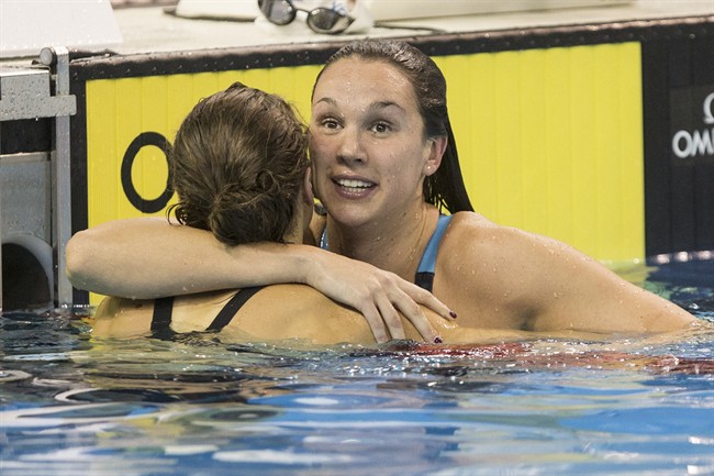 Chantal Vanlandeghem, right, is congratulated by Sandrine Mainville after winning the women's 50m freestyle event during the finals of the Canadian Olympic swimming trials in Toronto on Sunday, April 10, 2016.