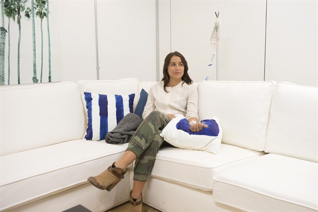 Laura Davidson sits with the IV infusion "Ultraviv," drip at Reviv in Toronto on Tuesday April 19, 2016. A new clinic promises to help Toronto's busy Bay Street financiers and overworked tech entrepreneurs cure their hangovers, shake off jet lag and even stave off the signs of aging through an intravenous drip. THE CANADIAN PRESS/