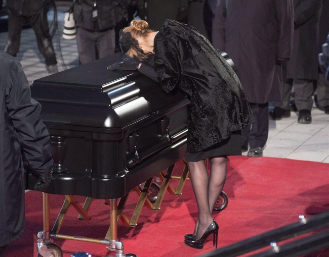Celine Dion kisses the casket after funeral services for her late husband René Angélil at Notre-Dame Basilica Friday, January 22, 2016 in Montreal.