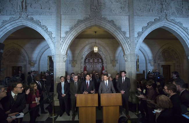 Surrounded by mayors and journalists Prime Minister Justin Trudeau and Vancouver Mayor Gregor Robertson take part in a news conference in the Foyer of the House of Commons on Parliament Hill in Ottawa on February 5, 2016. Providing infrastructure and services without adequate financial tools has been a major stress for municipalities of all sizes, and that's not the only obstacle they face, says Port Coquitlam Greg Moore. Mayors have used the change in the federal government to call for more autonomy for cities, which are straining under the weight of downloaded responsibilities from rental housing to daycare. Earlier this year, big-city mayors met with Prime Minister Justin Trudeau and urged Ottawa to directly fund building projects, bypassing the provinces altogether.