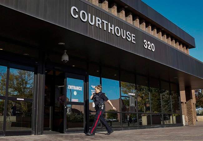 A police officer arrives at the provincial court building where the first court appearance of Derek James Saretzky in Lethbridge, Alta., Wednesday, Sept. 23, 2015.