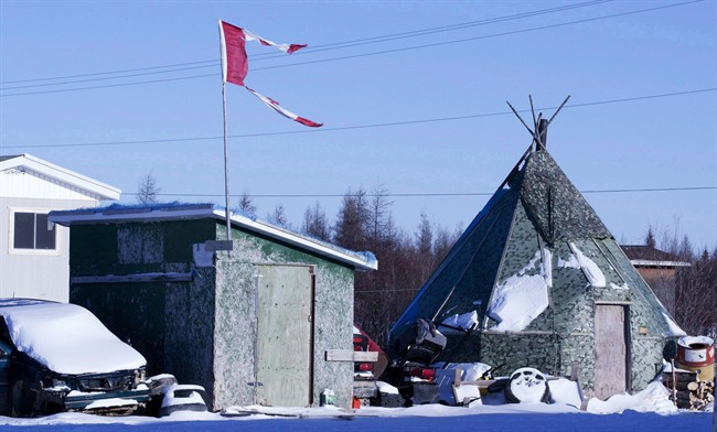 A tattered Canadian flag flies over a building in Attawapiskat, Ont., on November 29, 2011.