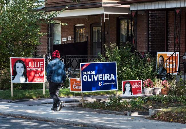 Campaign signs are seen on lawns in the Toronto riding of Davenport on Canada's federal election day on Monday, Oct. 19, 2015.