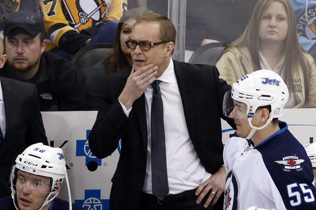 Winnipeg Jets head coach Paul Maurice, center, stands behind his bench during the first period of an NHL hockey game against the Pittsburgh Penguins in Pittsburgh.