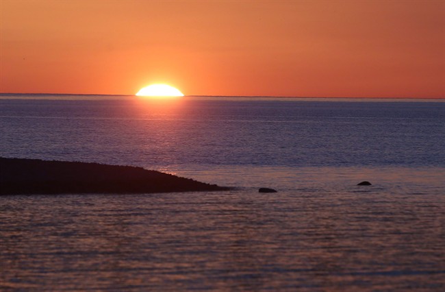 The sun sets over Lake Michigan in Mackinaw City, Mich., on May 5, 2015.