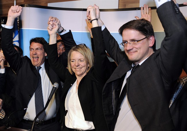 Pierre Karl Péladeau, Mireille Jean and Sylvain Gaudreault appear on stage following Jean's victory in the Chicoutimi byelection, Monday, April 11, 2016.
