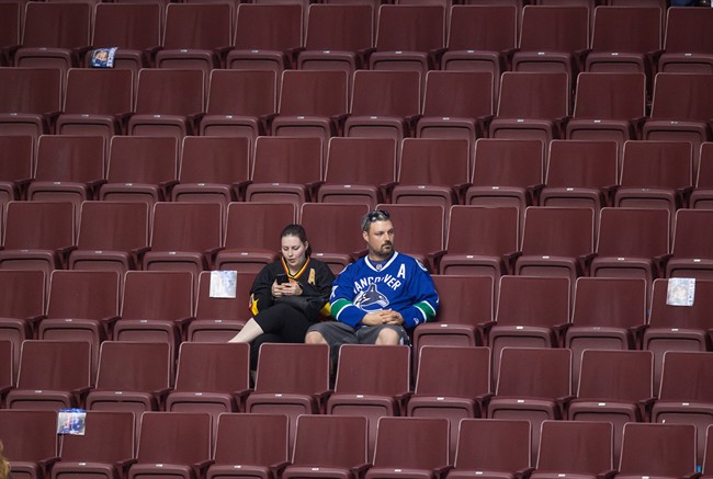 Vancouver Canucks fans sit in the stands after the team defeated the Edmonton Oilers in their final NHL hockey game of the season in Vancouver, B.C., on Saturday April 9, 2016. For the first time since 1970 not a single Canadian team made the NHL playoffs. 