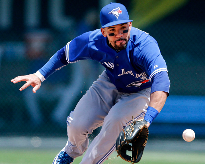 Toronto Blue Jays second baseman Devon Travis fields a ball hit by Kansas City Royals’ Mike Moustakas during the sixth inning of a baseball game at Kauffman Stadium in Kansas City, Mo., Saturday, July 11, 2015.