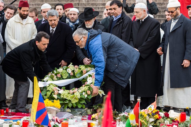 Chairman of the Belgian Muslim Executive Salah Echallaoui, 2nd left, Brussels Grand Rabbi, Albert Guigui, center, together with other religious leaders attend a ceremony organized by the Belgian Muslim Executive at a memorial site for the victims of the Brussels attacks at the Place de la Bourse in Brussels, Belgium, Friday, April 1, 2016. 
