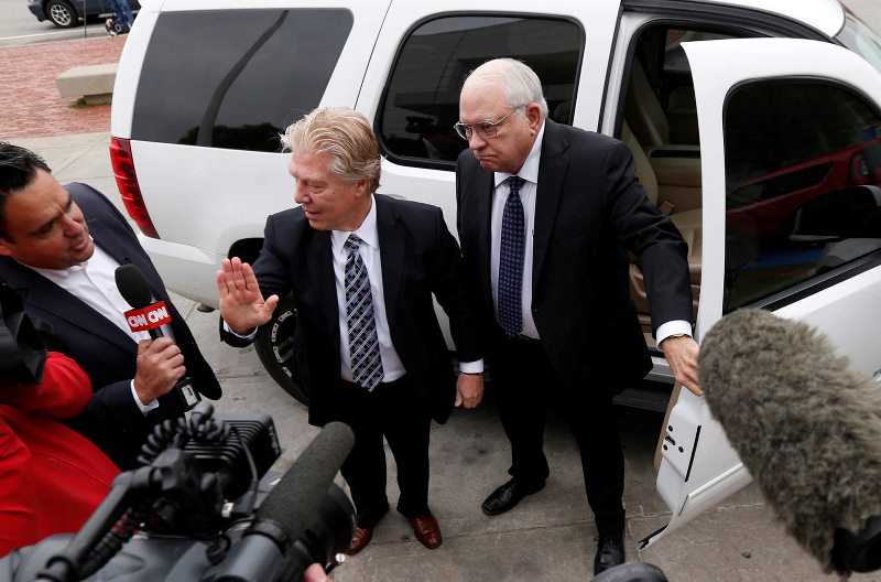 In this April 14, 2015 file photo, Robert Bates, right, arrives at the Tulsa County Jail with his attorney, Clark Brewster, in Tulsa, Okla. 