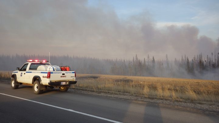 Fire crews battle a wildfire near Boyle, Alta. on April 18, 2016. The blaze briefly shut down Highway 63 in both directions.