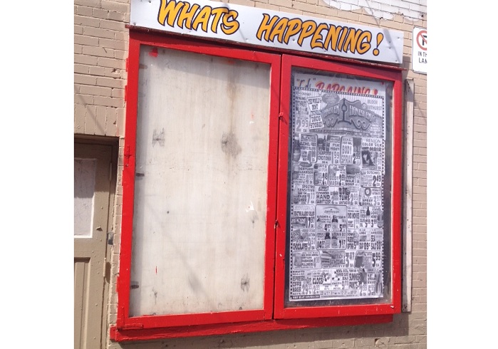 A hand-painted wooden sign was stolen from outside Honest Ed's on April 22, 2016.