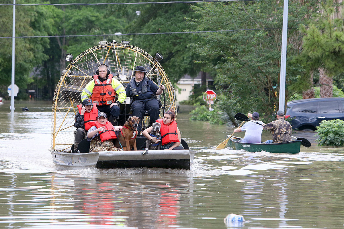 People and their pets are rescued from their homes near Nanes at Baltic in Houston, Texas, Wednesday, April 20, 2016.