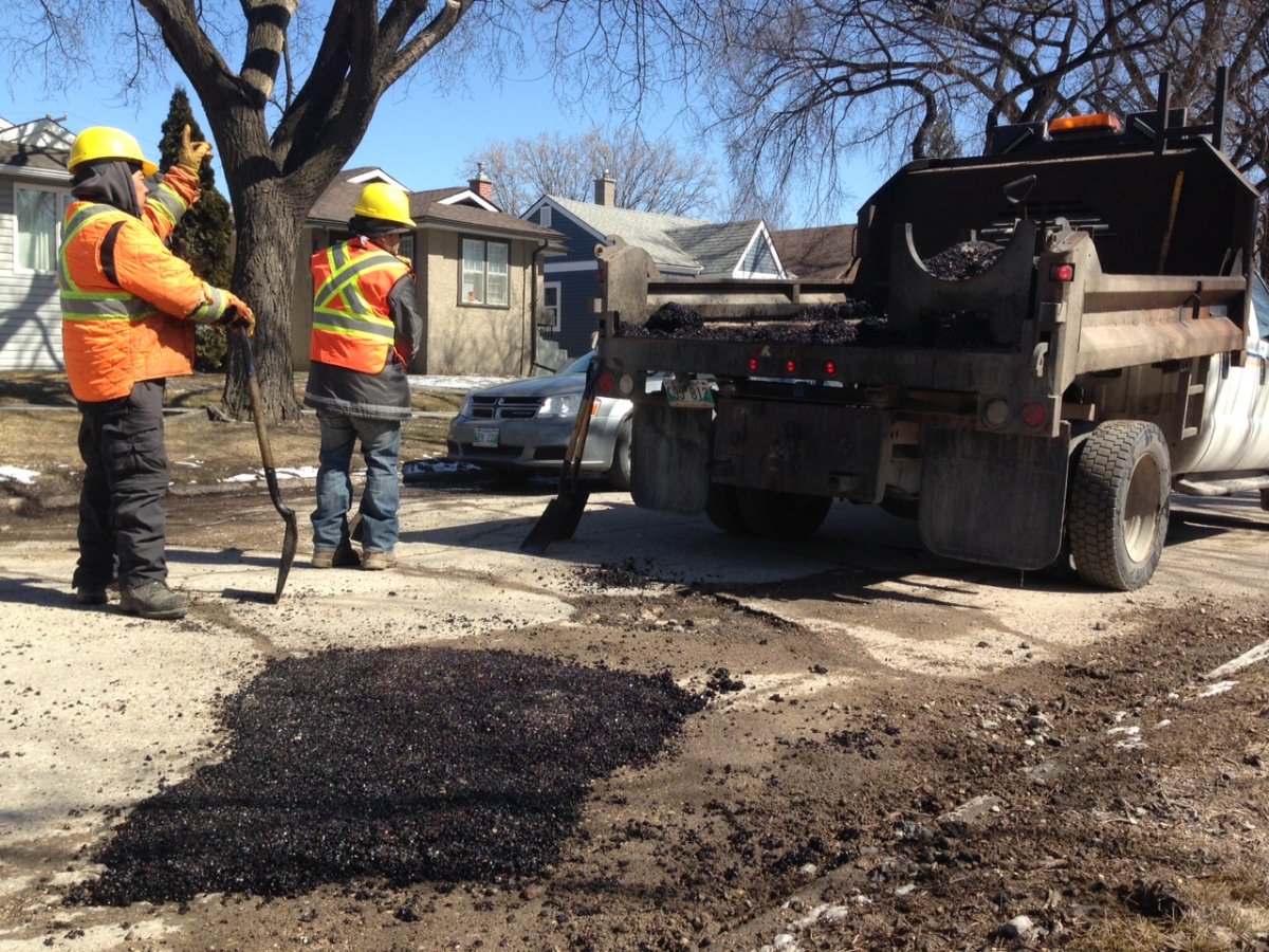 City crews patch a pothole. 