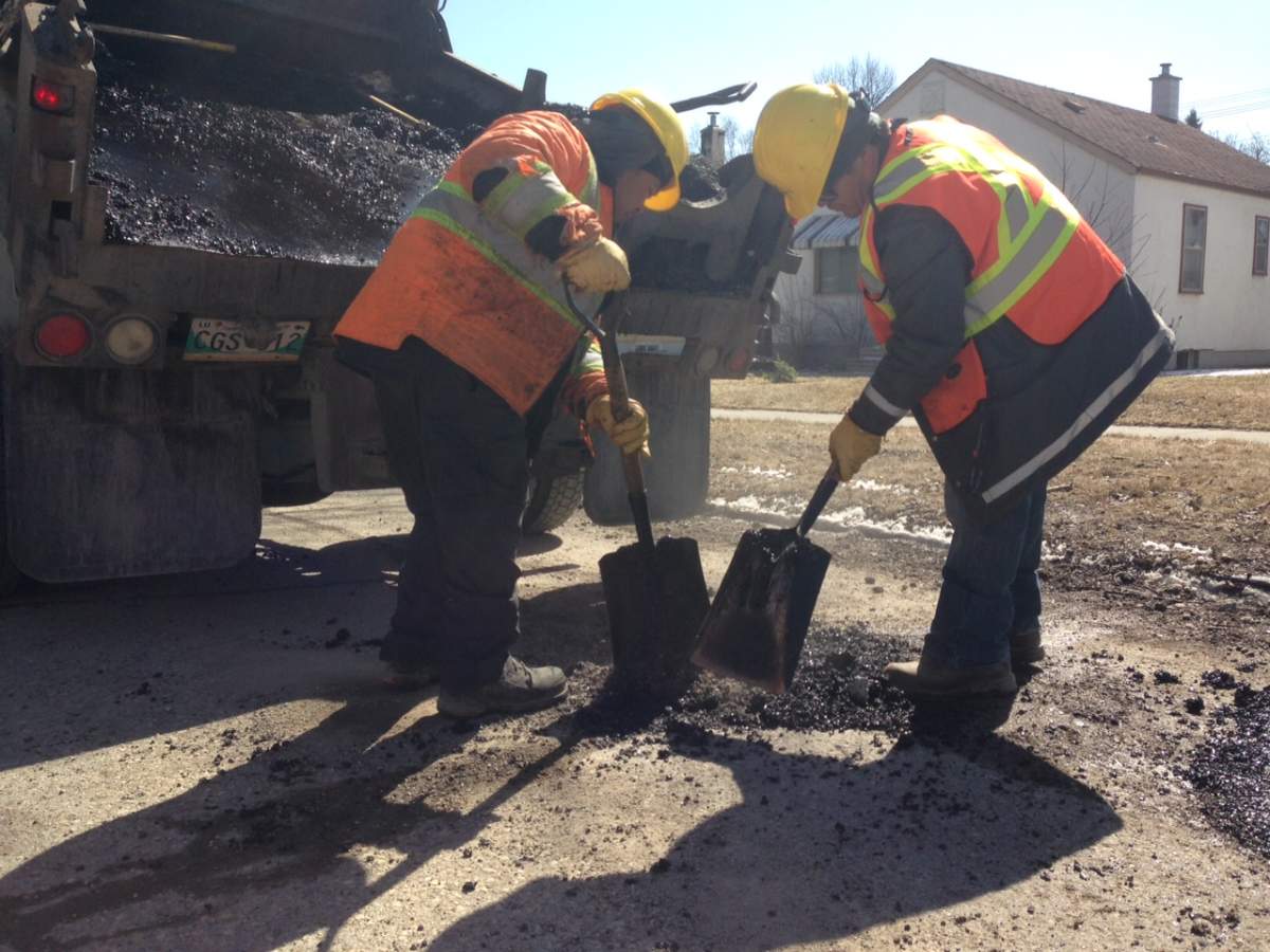 City crews patch a pothole Monday afternoon.