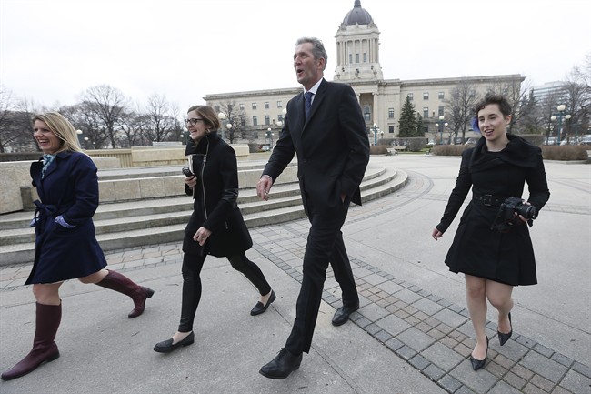 Manitoba PC leader and premier-elect Brian Pallister walks to a media conference with his communication staff outside the legislature in Winnipeg, Wednesday, April 20, 2016 the day after his party defeated the NDP with a majority. THE CANADIAN PRESS/John Woods.
