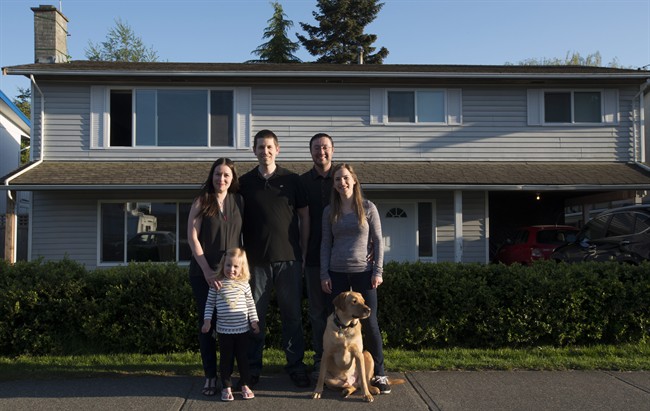 Jeremy Campbell along with his fiancee Holly Foran and dog Jake, right, shown in Delta, B.C., Monday, April, 25, 2016, bought a house together with Ryan and Christina Ingham and their two-year-old Regan. 