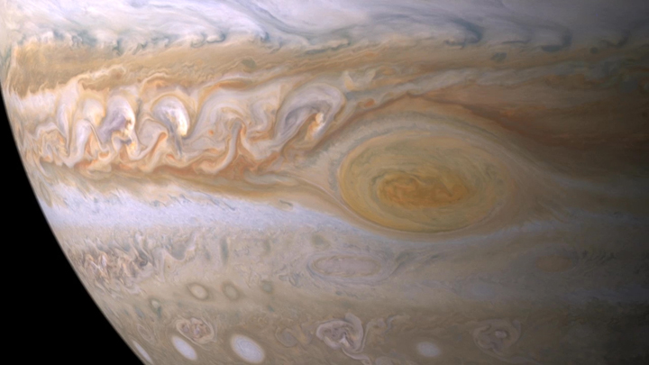 Trapped between two jet streams, the Great Red Spot is an anticyclone swirling around a center of high atmospheric pressure that makes it rotate in the opposite sense of hurricanes on Earth.