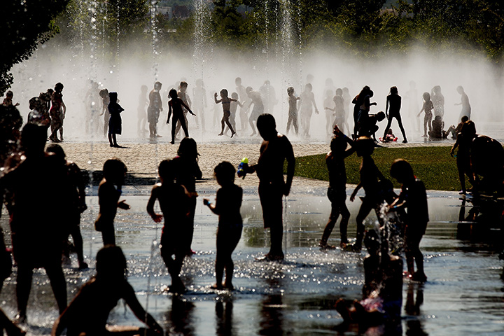 Children cool off as they play under a fountain in this July 21, 2015 file photo. 