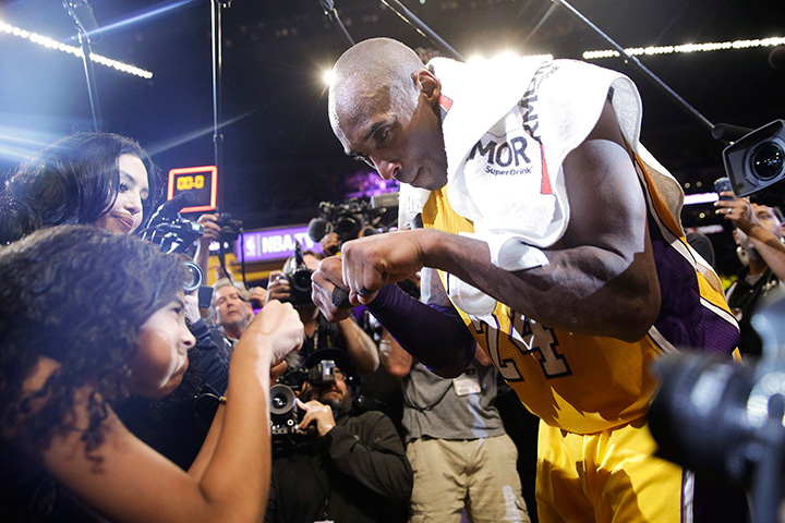 Los Angeles Lakers Kobe Bryant fist-bumps his daughter Gianna after the last NBA basketball game of his career, against the Utah Jazz on Wednesday, April 13, 2016, in Los Angeles. Bryant scored 60 points as the Lakers won 101-96.