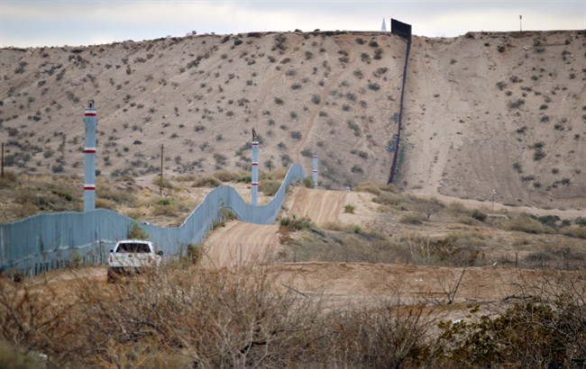 In this Jan. 4, 2016 file photo, a U.S. Border Patrol agent drives near the U.S.-Mexico border fence in Sunland Park, N.M. 