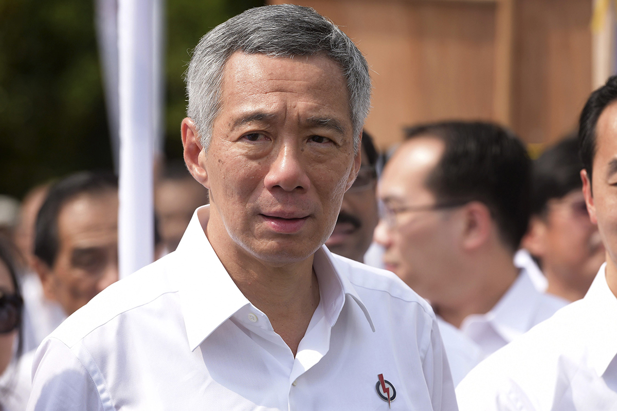  In this Sept. 1, 2015 file photo, Singapore's Prime Minister Lee Hsien Loong, secretary general of the ruling People's Action Party, makes his way to the election nomination center with other party members in Singapore for a general election scheduled on Sept. 11.