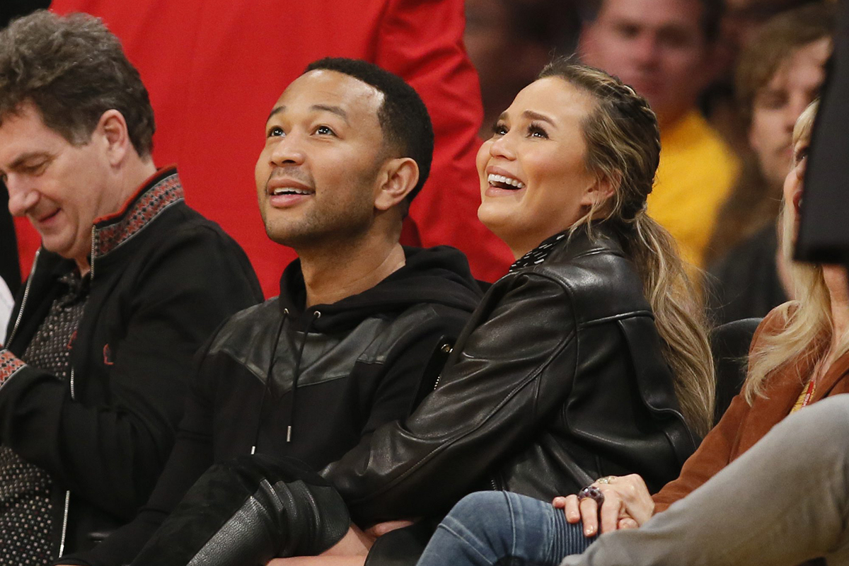  In a Thursday, March 10, 2016 file photo, musician John Legend, left, and model Chrissy Teigen, right, sit courtside during the first half of an NBA basketball game between the Los Angeles Lakers and Cleveland Cavaliers, in Los Angeles.