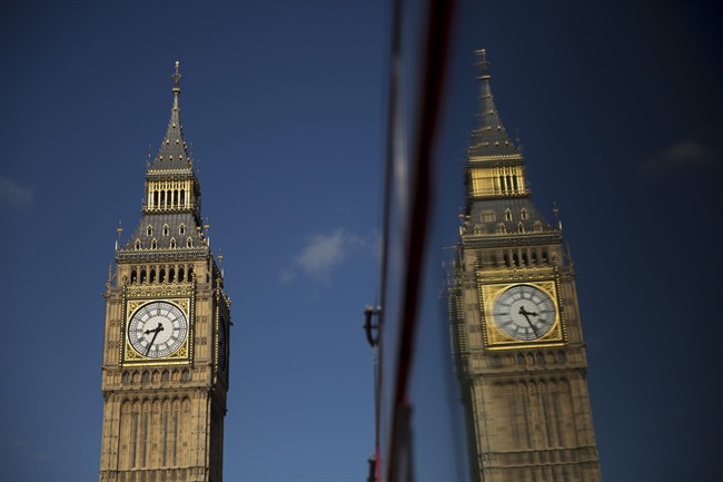 Elizabeth Tower, which houses the Big Ben bell, at the Houses of Parliament is reflected in a bus window in London, Tuesday, April 26, 2016. 