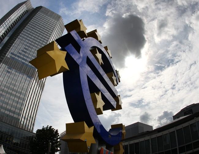 The euro sculpture is seen in front of the headquarters of the European Central Bank in Frankfurt, Germany, July 31, 2012.