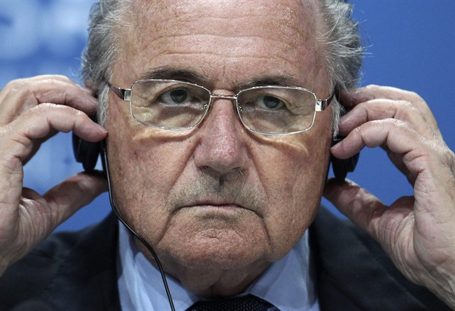 In this June 1, 2011 file photo, Sepp Blatter adjusts his headphones during a press conference after the 61st FIFA Congress in Zurich, Switzerland. 