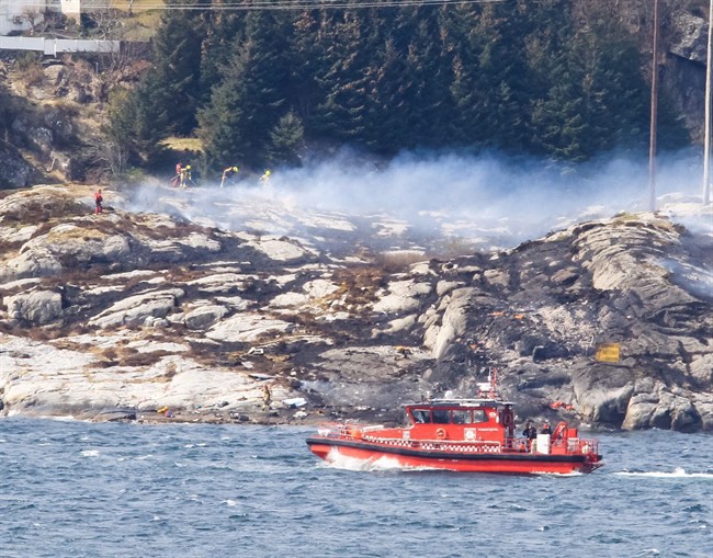 A search and rescue vessel patrols off the coast of the island of Turoey, near Bergen, Norway, as emergency workers attend the scene after a helicopter crashed believed to be have 13 people aboard, Friday April 29, 2016. A helicopter carrying around 13 people from an offshore oil field crashed Friday near the western Norwegian city of Bergen, police said. Many are feared dead.