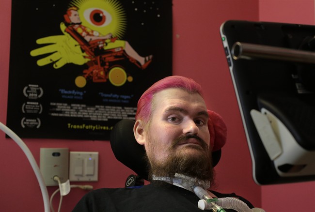In this Tuesday, March 22, 2016 photo filmmaker Patrick O’Brien, who was diagnosed with ALS in 2005 at age 30, sits for a portrait in Chelsea, Mass. His film "Transfatty Lives" won the audience award for best documentary at the Tribeca and Milan film festivals and a screening is slated for for Sunday, April 3, 2016, at the Showcase Cinemas in Revere, Mass. When O'Brien was no longer able to speak or move, he finished the film using a computer system that detects his eye movements so he can type out words on a screen.