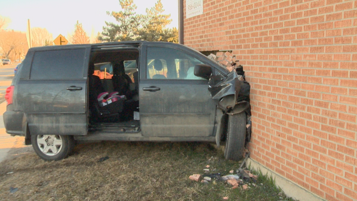 Police have a man in custody after a minivan crashes into a Saskatoon apartment building.