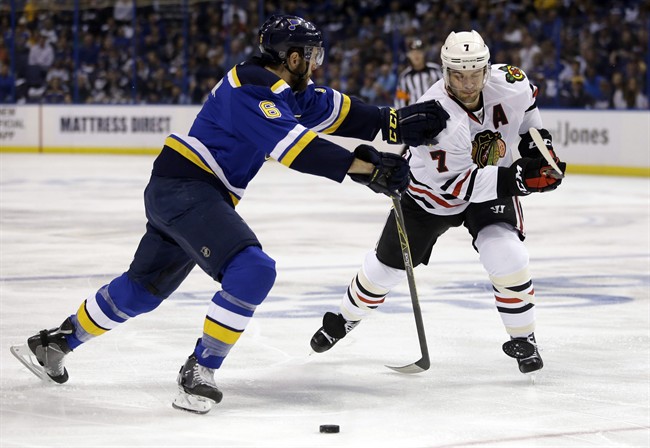 Chicago Blackhawks' Brent Seabrook, right, chases after the puck as St. Louis Blues' Joel Edmundson defends during the first period in Game 2 of an NHL hockey first-round Stanley Cup playoff series Friday, April 15, 2016, in St. Louis.