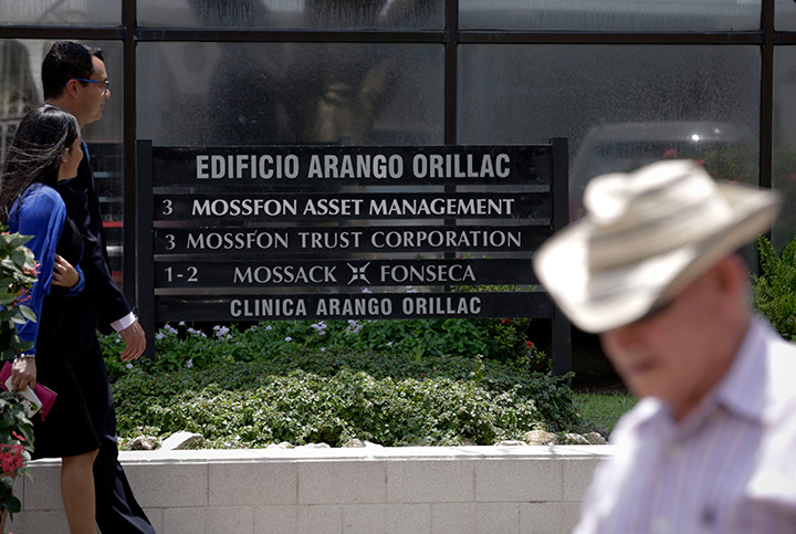 People walk past the Arango Orillac Building which lists the Mossack Fonseca law firm in Panama City, Tuesday, April 5, 2016. 