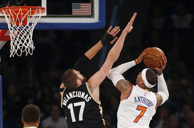 Toronto Raptors center Jonas Valanciunas (17) defends New York Knicks forward Carmelo Anthony (7) in the first half of an NBA basketball game at Madison Square Garden in New York, Sunday, April 10, 2016. (AP Photo/Kathy Willens).