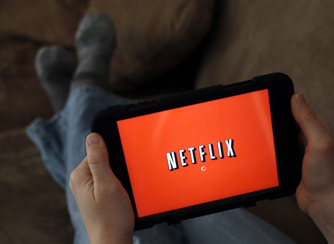 In this Friday, Jan. 17, 2014, file photo, a person displays Netflix on a tablet in North Andover, Mass. 