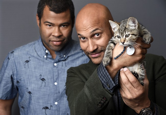 Jordan Peele, left, and Keegan-Michael Kay hold a ten-week-old tabby as they pose for a portrait to promote their film, "Keanu," at The Beverly Hilton Hotel in Beverly Hills, Calif.