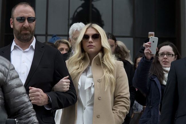  In this Feb. 19, 2016 file photo, pop star Kesha, center, leaves Supreme court in New York. 