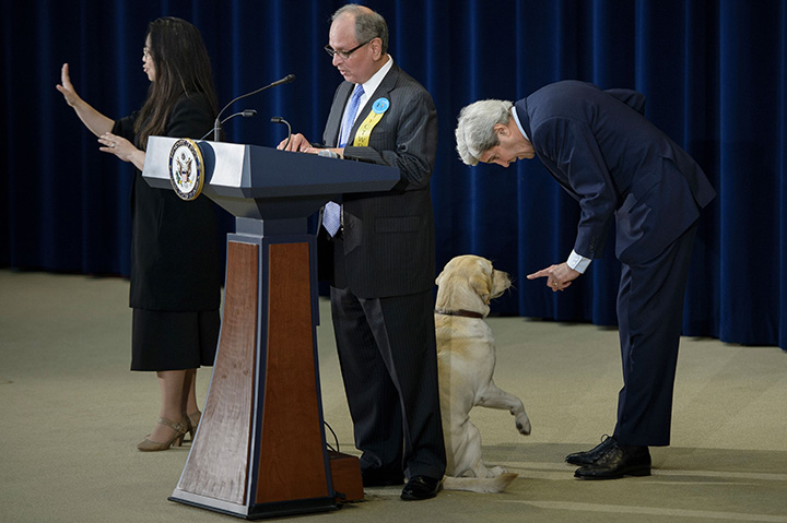 U.S. Secretary of State John Kerry calms his dog Ben while being introduced during an event to celebrate Take Your Child to Work Day at the U.S. Department of State April 28, 2016 in Washington, DC.