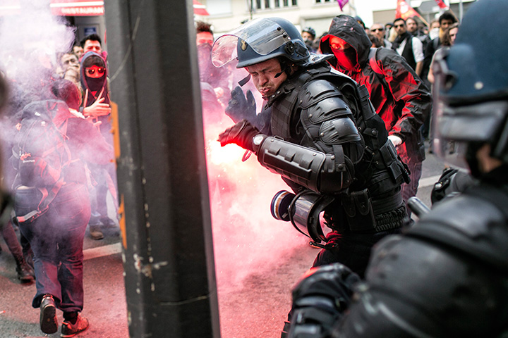 A police officer reacts during a clash with demonstrators during a protest against the proposed changes to France’s workweek and layoff practices, in Lyon on Thursday, April 28, 2016.