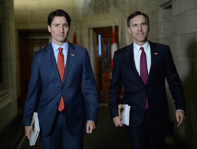 Minister of Finance Bill Morneau is accompanied by Prime Minister Justin Trudeau as he makes his way to deliver the federal budget in the House of Commons on Parliament Hill in Ottawa on Tuesday, March 22, 2016. 